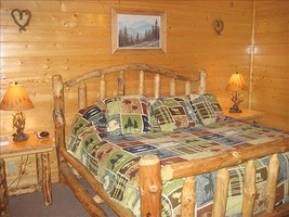 Cabin Master Suite features a king-sized bed, TV and bathroom