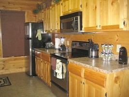 Kitchen has Stainless-Style appliances and spice rack